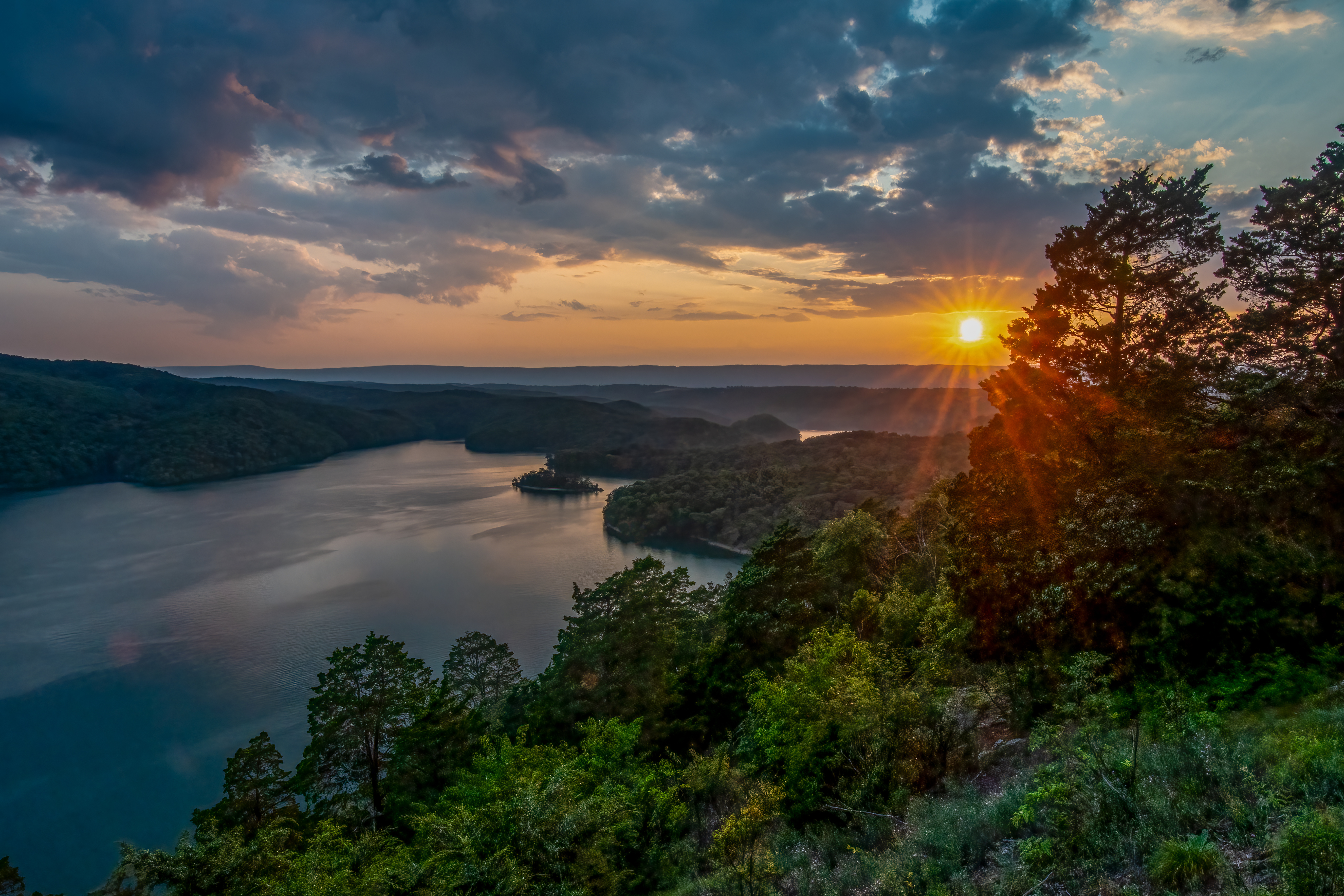 Sunset over Raystown Lake with rolling hills in the distance