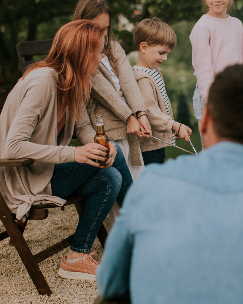 Family roasting food and enjoying time around a fire