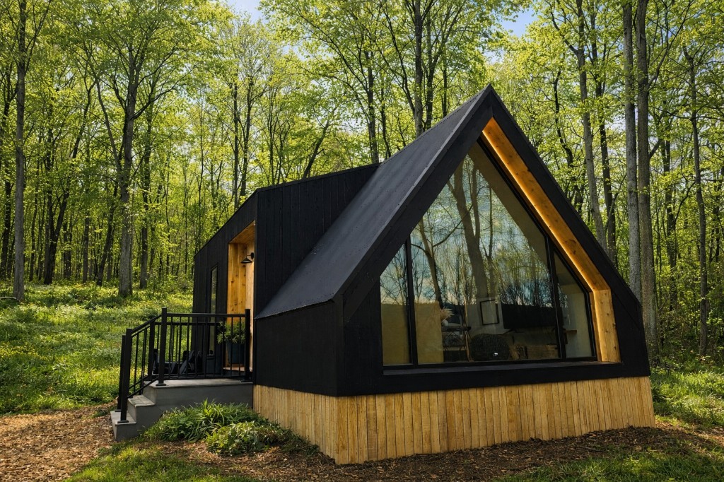 Bright tiny home living room with wood finishes and large windows